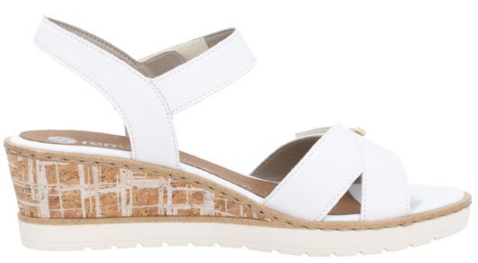 White sandal with cork wedge heel and adjustable straps.