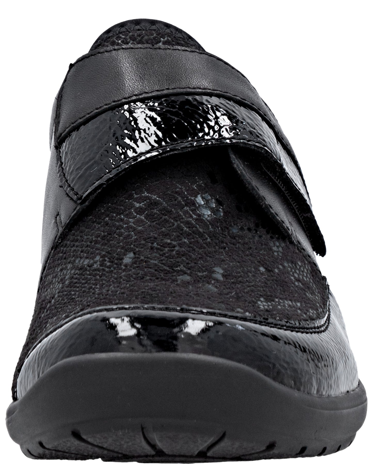 A close-up, front-facing view of a black shoe featuring a shiny patent leather toe cap and matching cross-strap, contrasted with a textured, snakeskin-patterned upper.