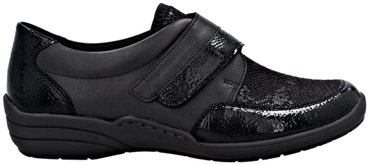 A black orthopedic shoe with a textured, snakeskin-like pattern on the heel, toe, and velcro strap, featuring a smooth side panel and a thick, dark gray sole.