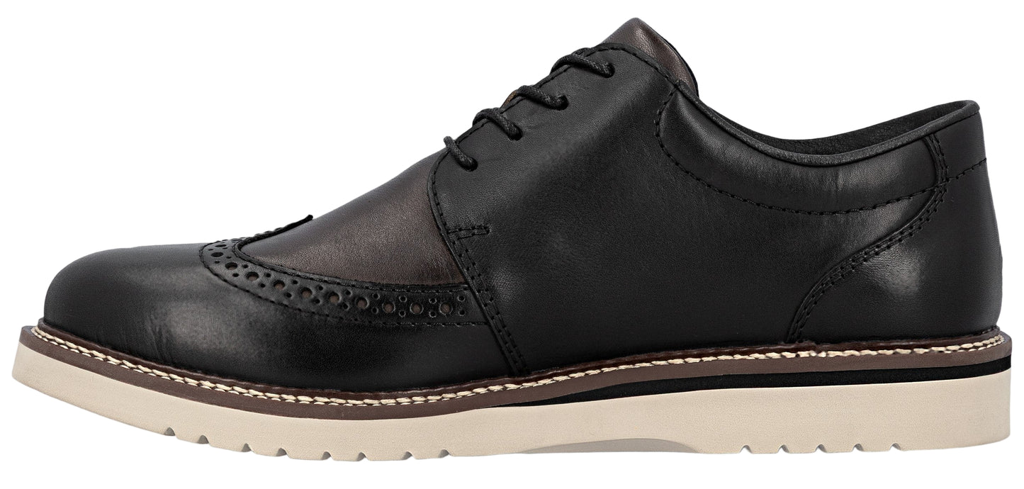 A black leather wingtip dress shoe with a light-colored sole.