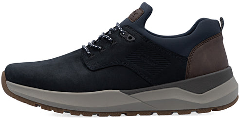 A side view of a navy blue sneaker with dark brown heel panel, gray midsole, and brown rubber outsole, featuring textured side paneling, dark blue laces, and a branded tongue label.