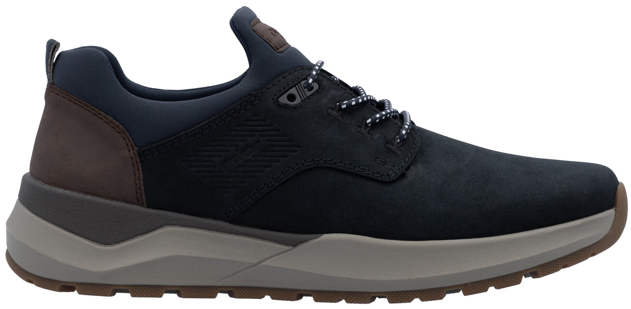 A low-top men's sneaker in dark navy blue leather and synthetic material, featuring a brown leather heel panel, a thick grey midsole, and a brown rubber outsole with patterned laces.