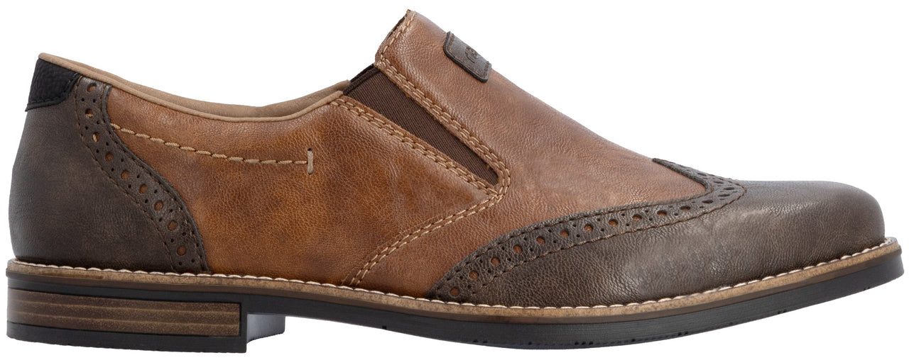 A slip-on shoe featuring a two-tone design with light tan leather side panels, dark brown leather detailing on the heel and toe with decorative brogue perforations, and a low stacked heel.