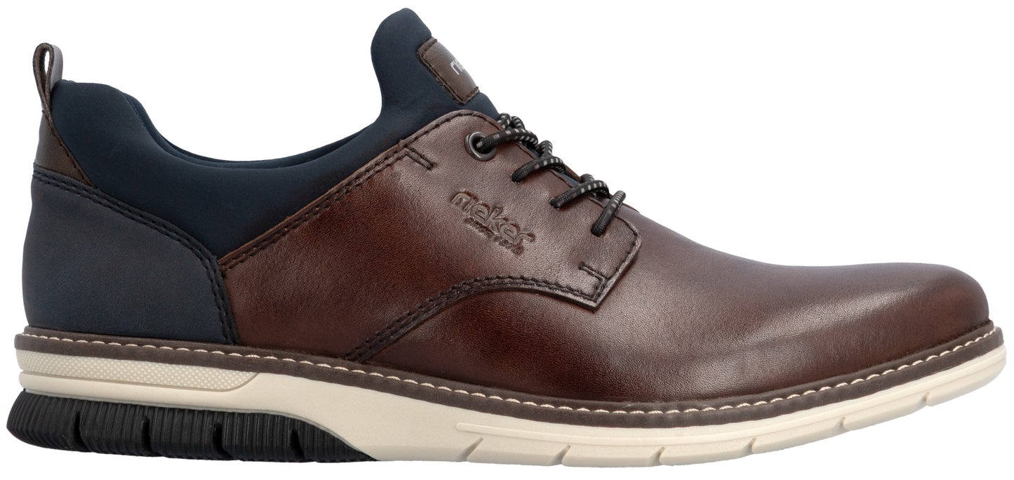 A brown leather and dark blue fabric casual shoe with a lace-up closure and a white and black rubber sneaker-style sole, featuring the brand name rieker embossed on the side.