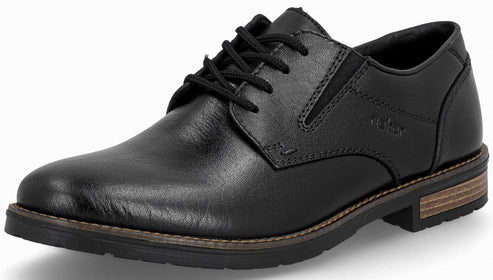 A black leather derby shoe with a lace-up closure, visible stitching, and a multi-layered textured sole with a wood-look detail.