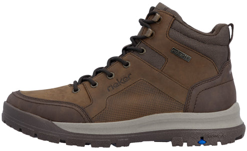 A brown leather and textile ankle boot with a lace-up front, a grey mid-sole, a dark brown lugged outer sole with a small blue accent, and the brand name Rieker embossed on the side.