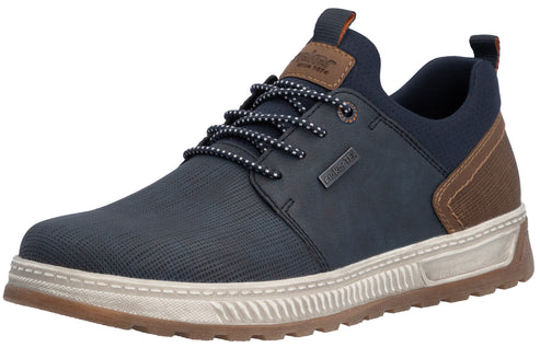 A low-top, navy blue, casual sneaker with a textured mesh upper, dark blue synthetic side panel with a 'RiekerTEX' tag, brown patterned heel accent, dark navy and white speckled laces, a brown leather tongue tab, and a thick, textured, off-white midsole with a brown outsole.