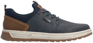 A low-top sneaker with a dark blue navy upper, brown textured heel panel, and a white ridged midsole with a brown treaded outsole. It features navy laces, a padded navy collar, and a small dark rectangular branded tag on the lateral side.