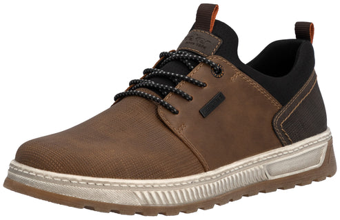 A brown and black lace-up sneaker with a textured brown fabric forefoot, tan leather overlays, a black padded collar, black patterned laces, and a thick, ridged white sole with brown accents.