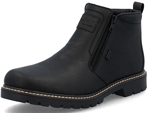 A black leather ankle boot with a side zipper closure, a padded ankle collar, a pull tab at the heel, and a thick, lugged black rubber outsole with a white stitched welt.