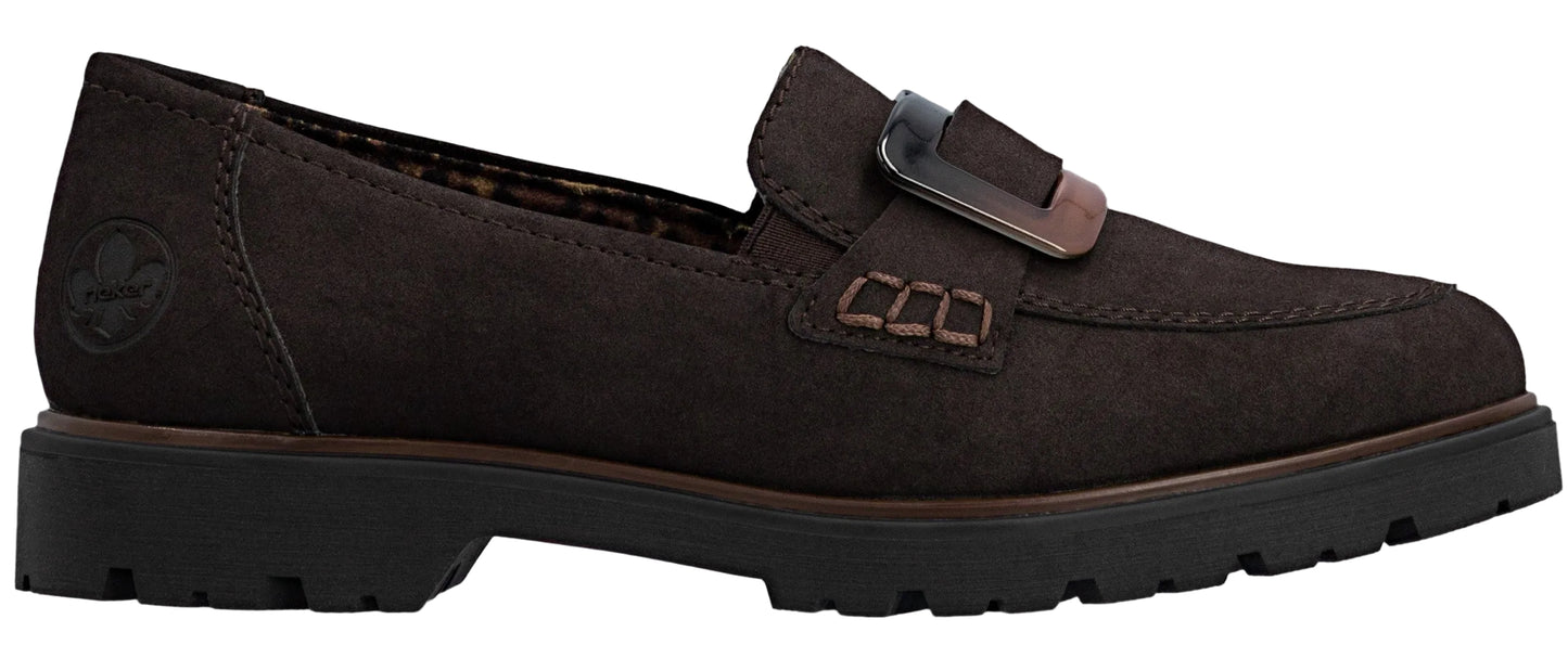 A dark brown suede loafer with a chunky black lug sole and a decorative buckle on the front.