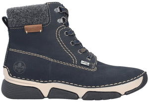 A dark blue leather ankle boot with grey wool trim at the cuff, a tan welt with white stitching, and a thick, chunky beige and black rubber sole, viewed from the side.