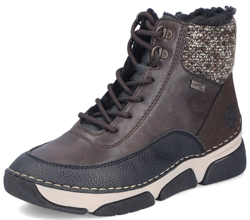 A brown leather ankle boot with a black textured toe cap, a knitted collar, black laces, a Rieker Tex logo tag on the side, and a two-toned white and black rubber sole.