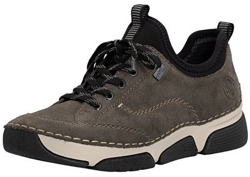 A gray suede lace-up sneaker with black accents on the heel collar and laces, featuring a thick off-white midsole and a black, textured rubber outsole, with visible decorative stitching along the sides and a small gray tag on the side.