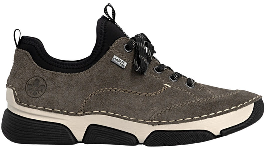 A gray suede Rieker brand sneaker with a thick, cream-colored midsole and a black rubber outsole. It features black laces, a black elastic ankle collar, a pull tab at the back, and the Rieker logo embossed on the side.
