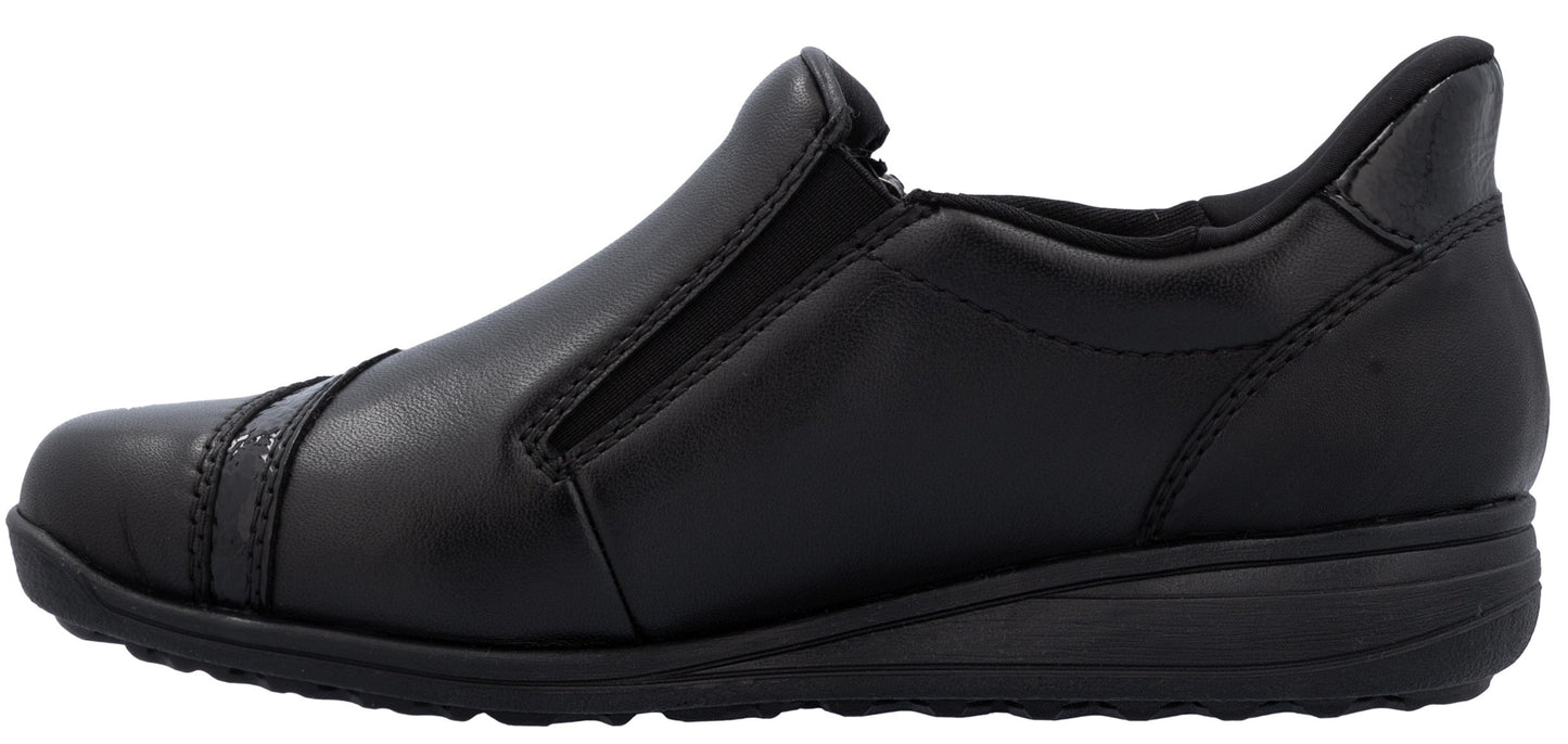 A black slip-on shoe with a low wedge heel.