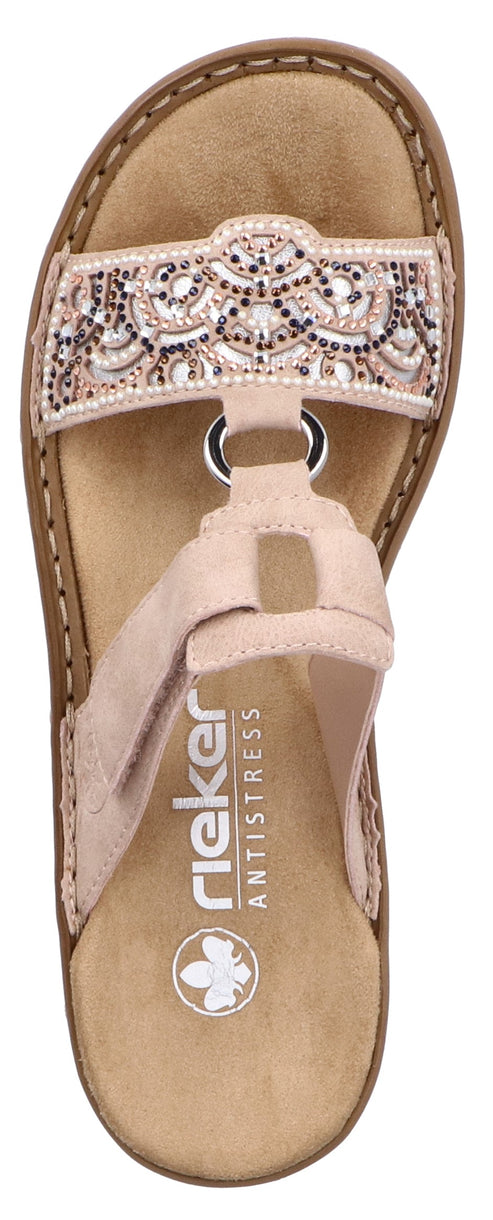 A pink sandal with a beaded strap and the word rieker on the footbed.