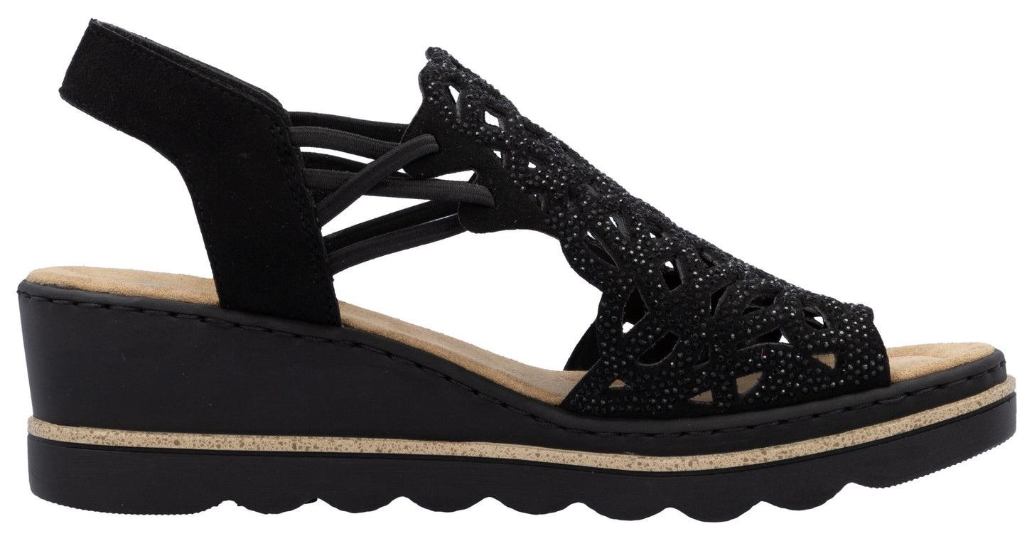 Black wedge sandal with laser-cut pattern and slingback strap.
