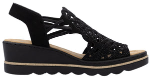 Black wedge sandal with laser-cut pattern and slingback strap.