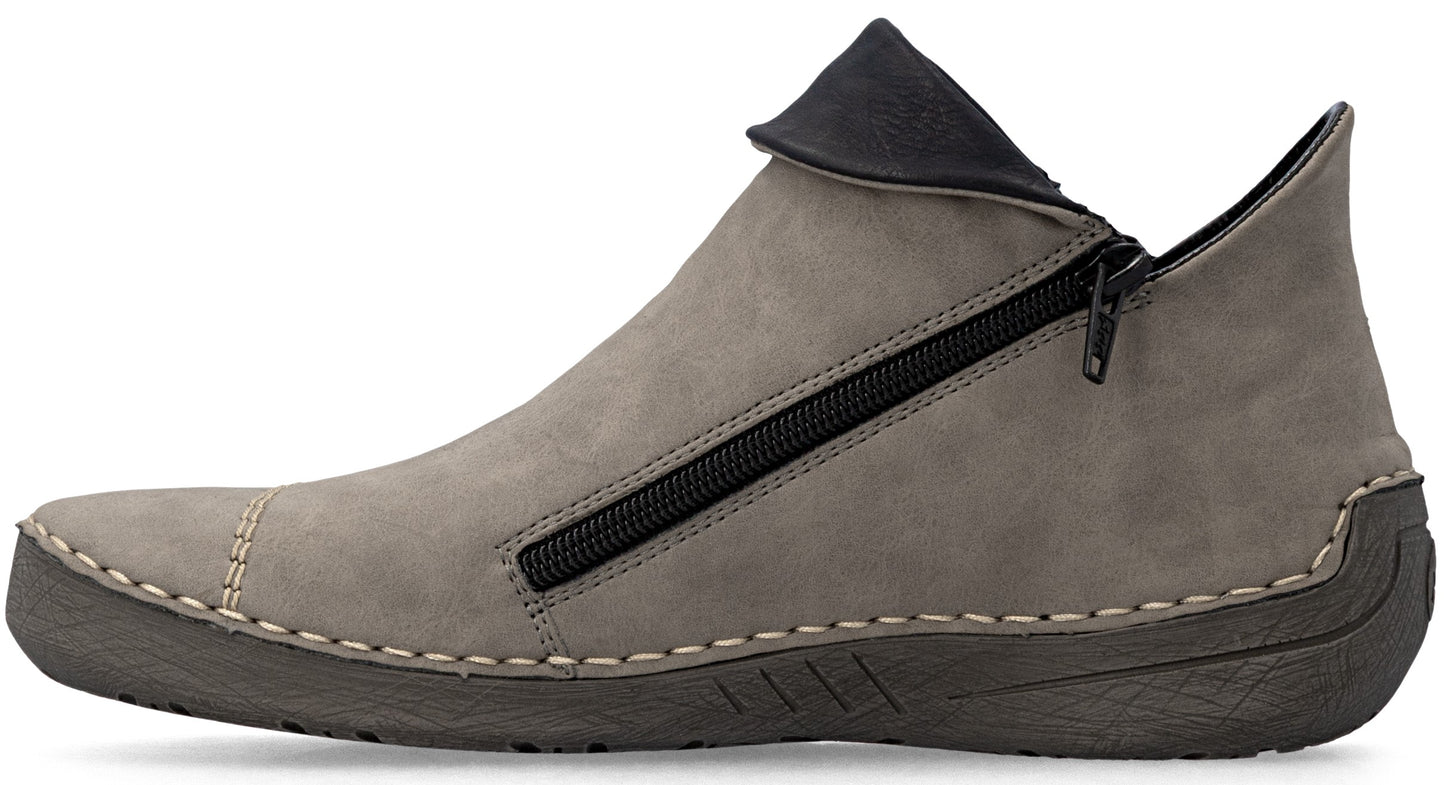 A gray ankle boot with a side zipper closure, featuring a soft, matte upper, contrasting dark gray heel and toe accents, visible light stitching along the sole, and a dark textured rubber outsole.