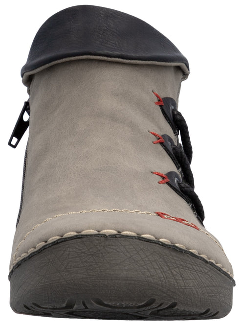 A grey ankle boot viewed from the front, featuring a dark brown rubberized toe cap, white decorative stitching along the sole, a side zipper, and three black toggle closures with red stitching accents.