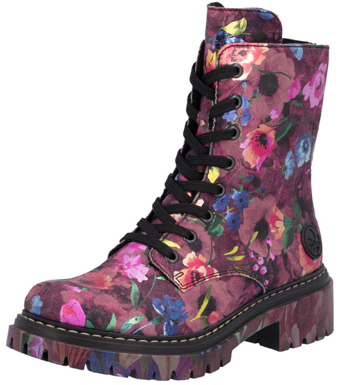 A floral print combat boot with a deep purple base, black laces, a side zipper, and a chunky lugged sole.