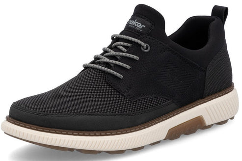 A black textile shoe with gray laces and a thick, light-colored sole featuring brown accents.