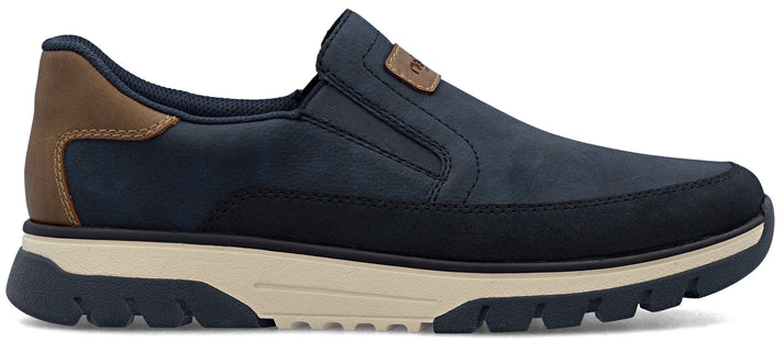 A slip-on shoe in navy with a brown heel and a thick, light-colored sole.