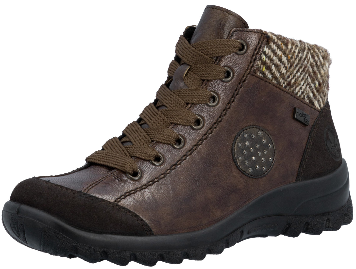 A brown lace-up ankle boot with a textured herringbone patterned collar, a dark brown suede toe cap, and a circular rivet-embellished detail on the side, set on a thick black lugged rubber sole.