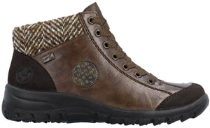 A brown ankle boot featuring a lace-up front, a dark herringbone pattern textile collar, a leather-like main panel with a circular textured detail, a darker brown suede-like overlay at the heel and toe, and a sturdy black rubber sole.