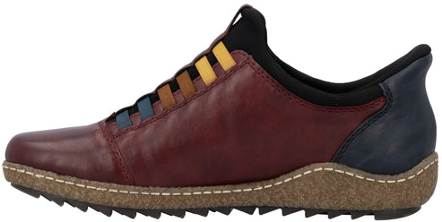 A slip-on shoe with a maroon leather upper, a dark blue heel panel, and colorful elastic lace detailing in blue, brown, and yellow. The shoe has a cork-textured midsole with white stitching and a dark, sawtooth-patterned rubber outsole.