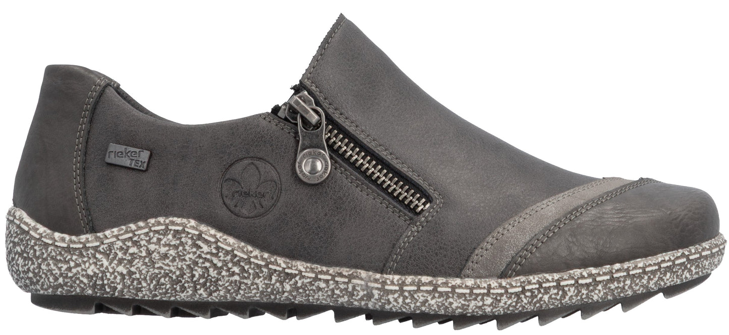 A gray Rieker TEX slip-on shoe with a side zipper, featuring a speckled, textured midsole with visible stitching and a lugged sole.