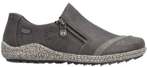 A gray Rieker TEX slip-on shoe with a side zipper, featuring a speckled, textured midsole with visible stitching and a lugged sole.