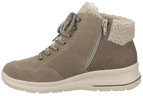 A light brown suede ankle boot with a lace-up front, a side zipper closure, a faux shearling collar, and a thick off-white ridged rubber sole.