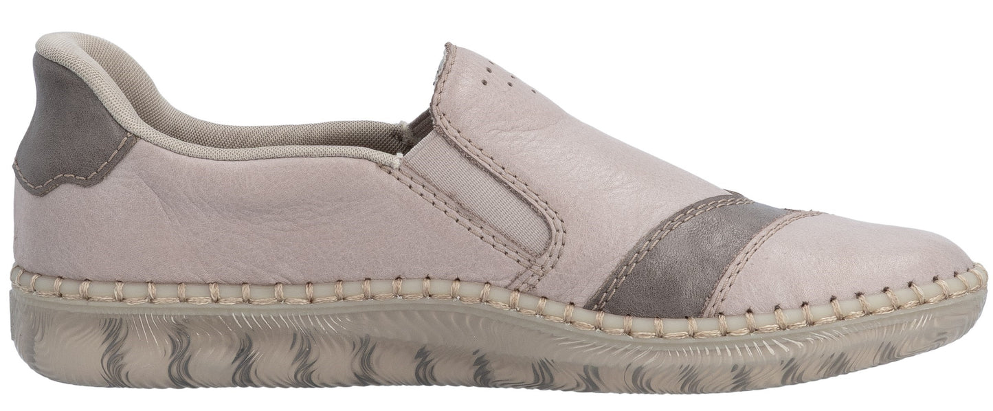 A slip-on shoe with a textured sole and a beige and gray upper.