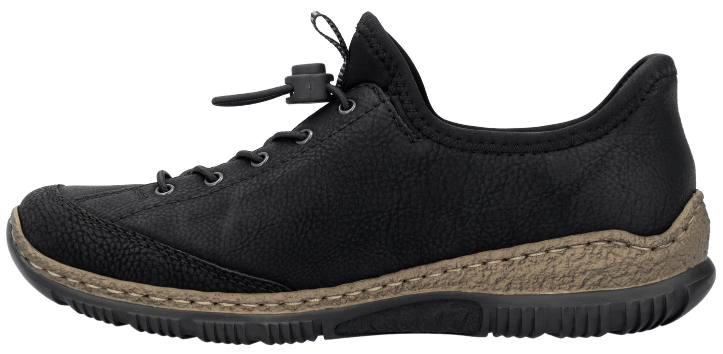 A black slip-on shoe with a textured toe and heel, a toggle lace closure system, and a thick, tan, textured midsole above a black rubber outsole.