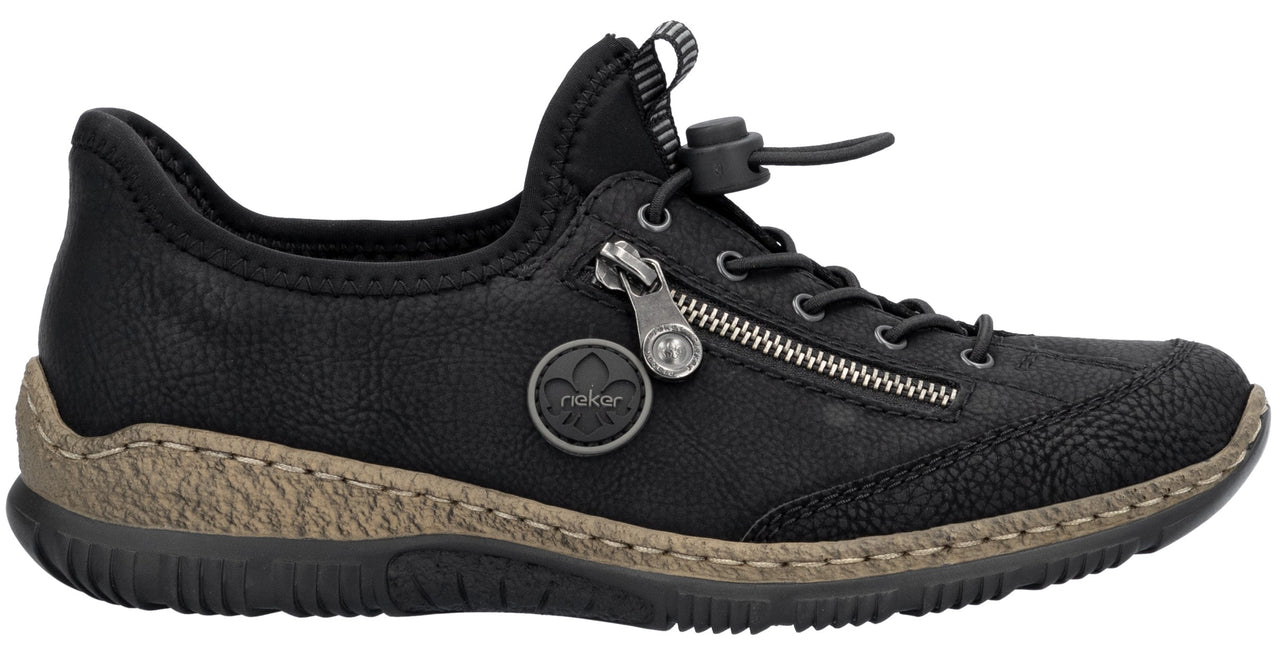 A black leather slip-on shoe with a side zipper detail, a toggle lace closure system, a textured beige midsole, and a black rubber outsole.