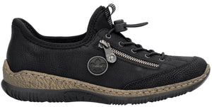 A black leather slip-on shoe with a side zipper detail, a toggle lace closure system, a textured beige midsole, and a black rubber outsole.