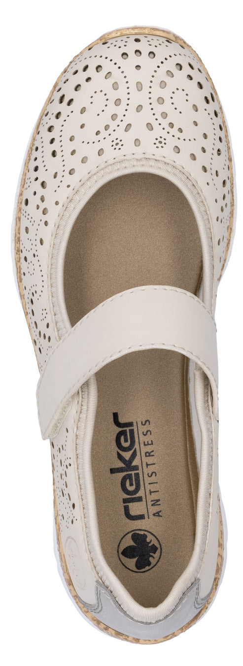 A cream-colored, Mary Jane style shoe with decorative perforations and a strap across the foot.