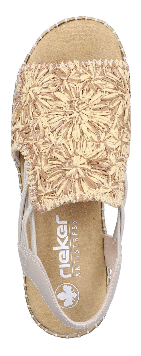 A sandal with a beige floral pattern on the top strap, a beige sole with visible white stitching, and a back strap.