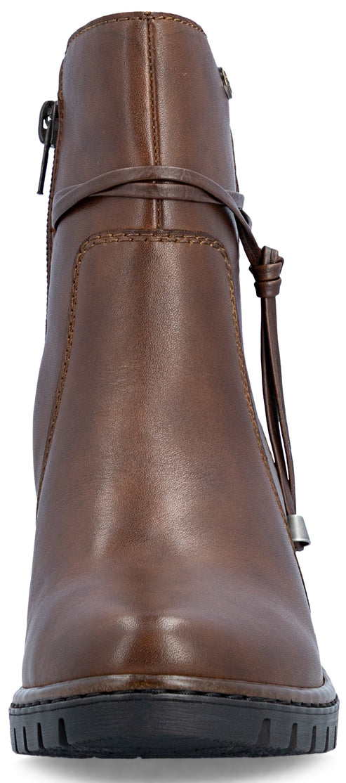 A front view of a brown leather ankle boot with a side zipper, a decorative wrap-around ankle strap with a side knot detail, and a thick black lug sole.