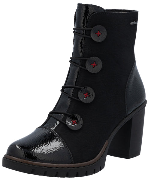 A black ankle boot with a block heel, a textured patent leather toe cap, a glossy black vertical panel along the front, and four large circular decorative buttons with red cross-stitch detail on the side.