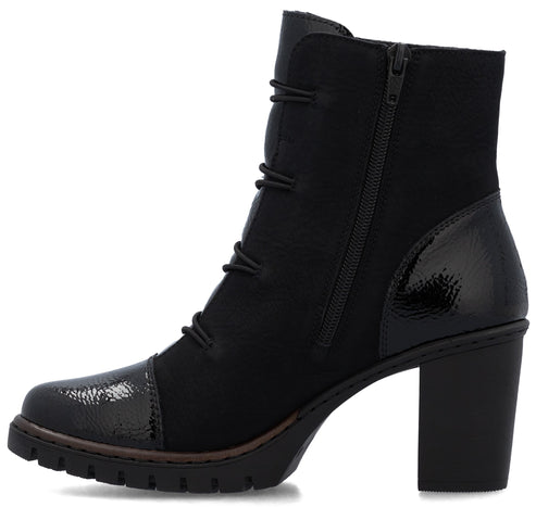 A black ankle boot with a high block heel, a textured glossy toe cap, and a matching glossy panel on the heel. The boot features a side zipper closure and decorative lacing along the front with a chunky, lugged sole.