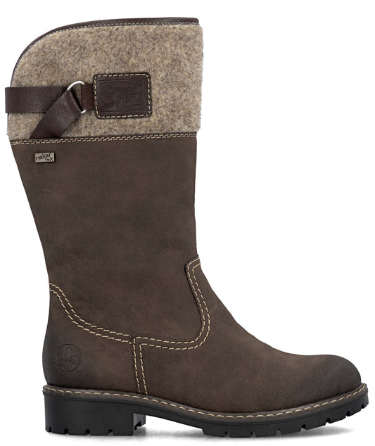 A brown, mid-calf women's winter boot with a lug sole, featuring a tan felt cuff at the top, a dark brown decorative strap with a buckle detail, and contrast stitching along the side panels.