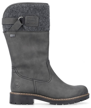 A gray mid-calf women's winter boot with a smooth synthetic upper, a dark gray felt collar at the top, a decorative strap with a buckle detail, a small square patch that reads "rieker 1874", a small tag on the side, and a chunky black lug sole.
