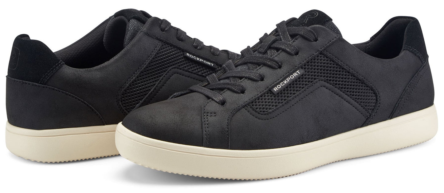 A pair of black sneakers with cream soles.