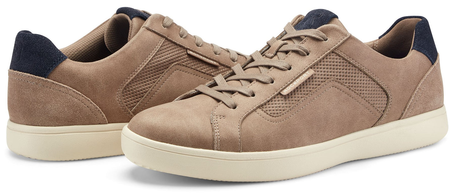 A pair of light brown leather sneakers with a dark blue heel and white soles.