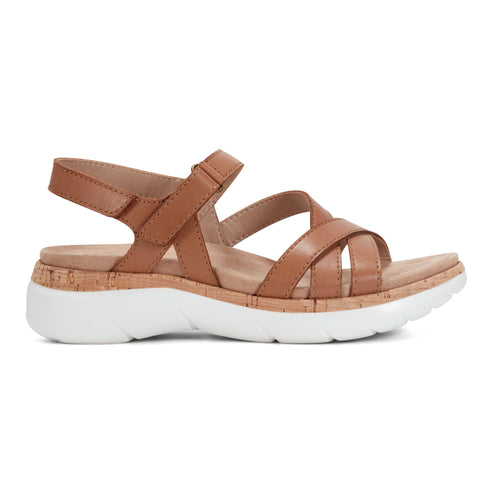 Tan sandal with adjustable velcro strap and white platform sole.