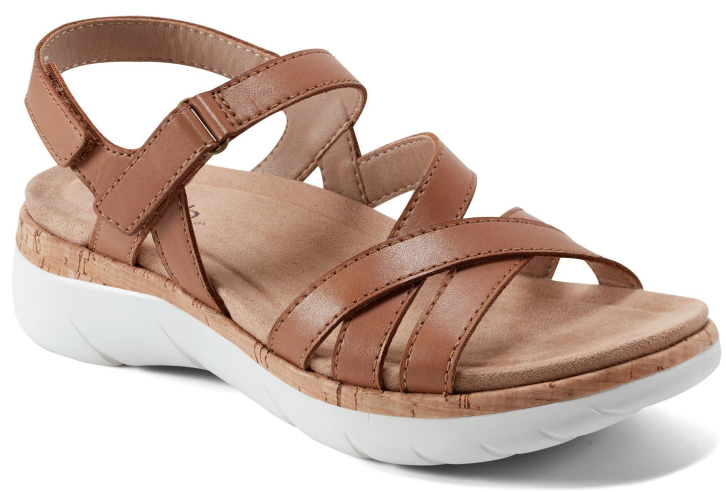 Tan sandal with criss-cross straps and a white sole.