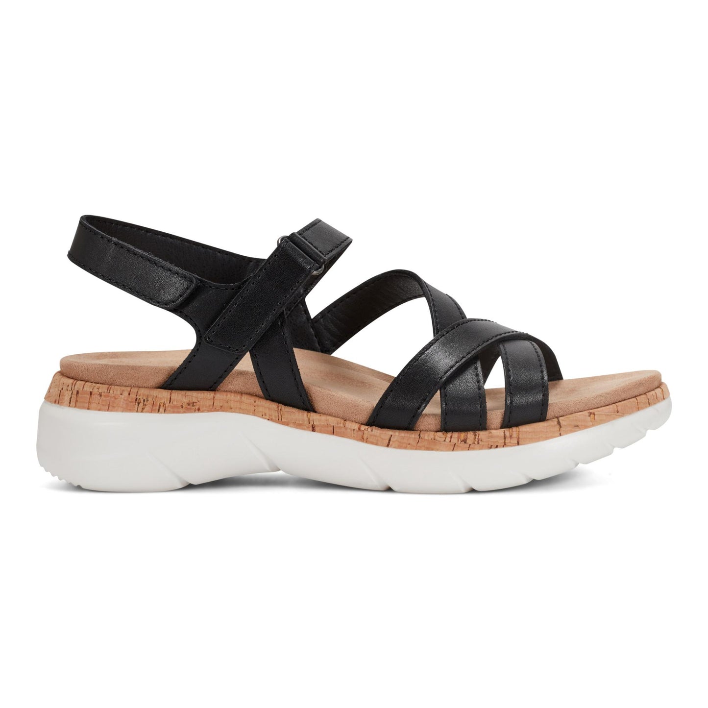 Black sandal with straps, velcro ankle strap, cork layer, and white textured sole.